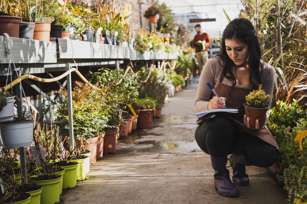 gardener-making-notes-about-flower - Redmonds Garden Center